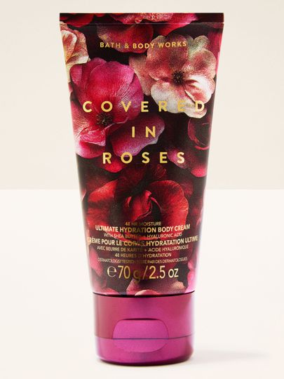Mini tělový krém Covered in Roses Bath & Body Works v tmavé květinové tubě s výrazným růžovým akcentem