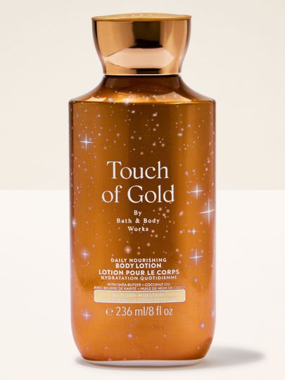 Tělové mléko Touch of Gold od Bath & Body Works ve zlaté lahvi s hydratační a rozjasňující formulí.