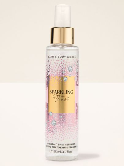 Diamond Shimmer Mist Sparkling Toast Bath & Body Works v růžovo‑zlaté lahvi s třpytivými částicemi