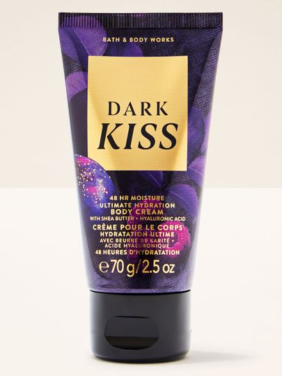 Tělový krém Dark Kiss v tubě s fialovo‑zlatým, třpytivým designem.