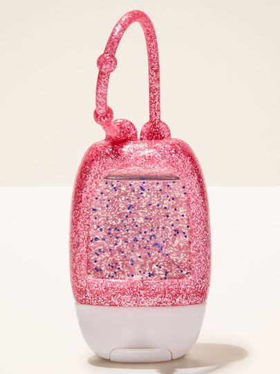 Třpytivý růžový držák na PocketBac z pružného materiálu, určený pro snadné uchycení mini dezinfekčního gelu.