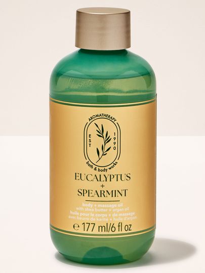 Masážní olej Bath & Body Works "Eucalyptus + Spearmint" s bambuckým máslem a arganovým olejem, v zelené lahvi.