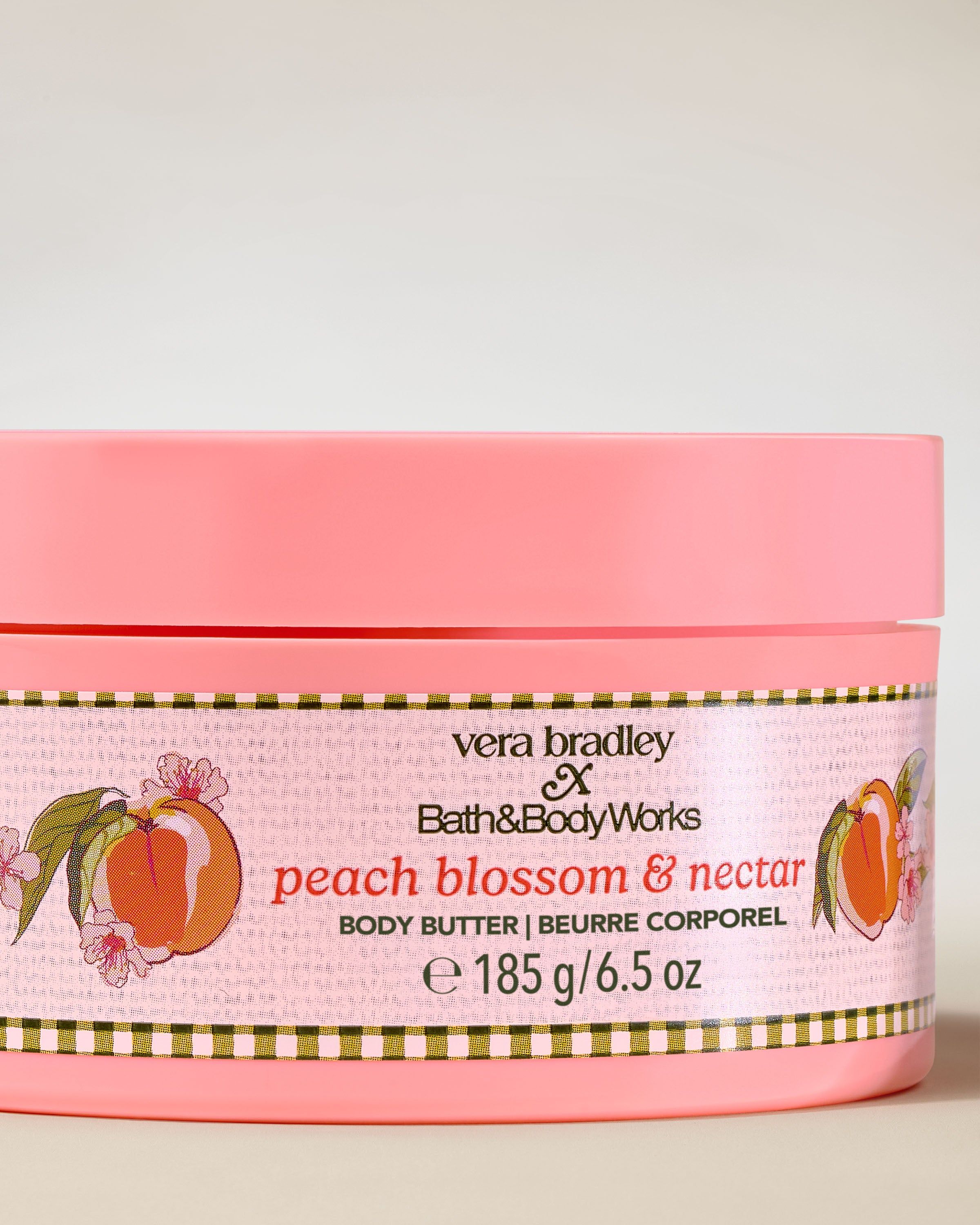 Bath & Body Works Peach Blossom & Nectar – tělové máslo v růžové dóze s dekorativním broskvově‑květinovým štítkem.