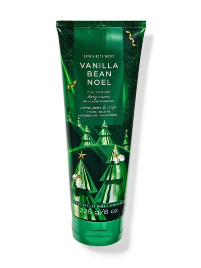 Ciemnozielony krem do ciała z motywem choinek i złotymi gwiazdkami na wieczór. Bath & Body Works.