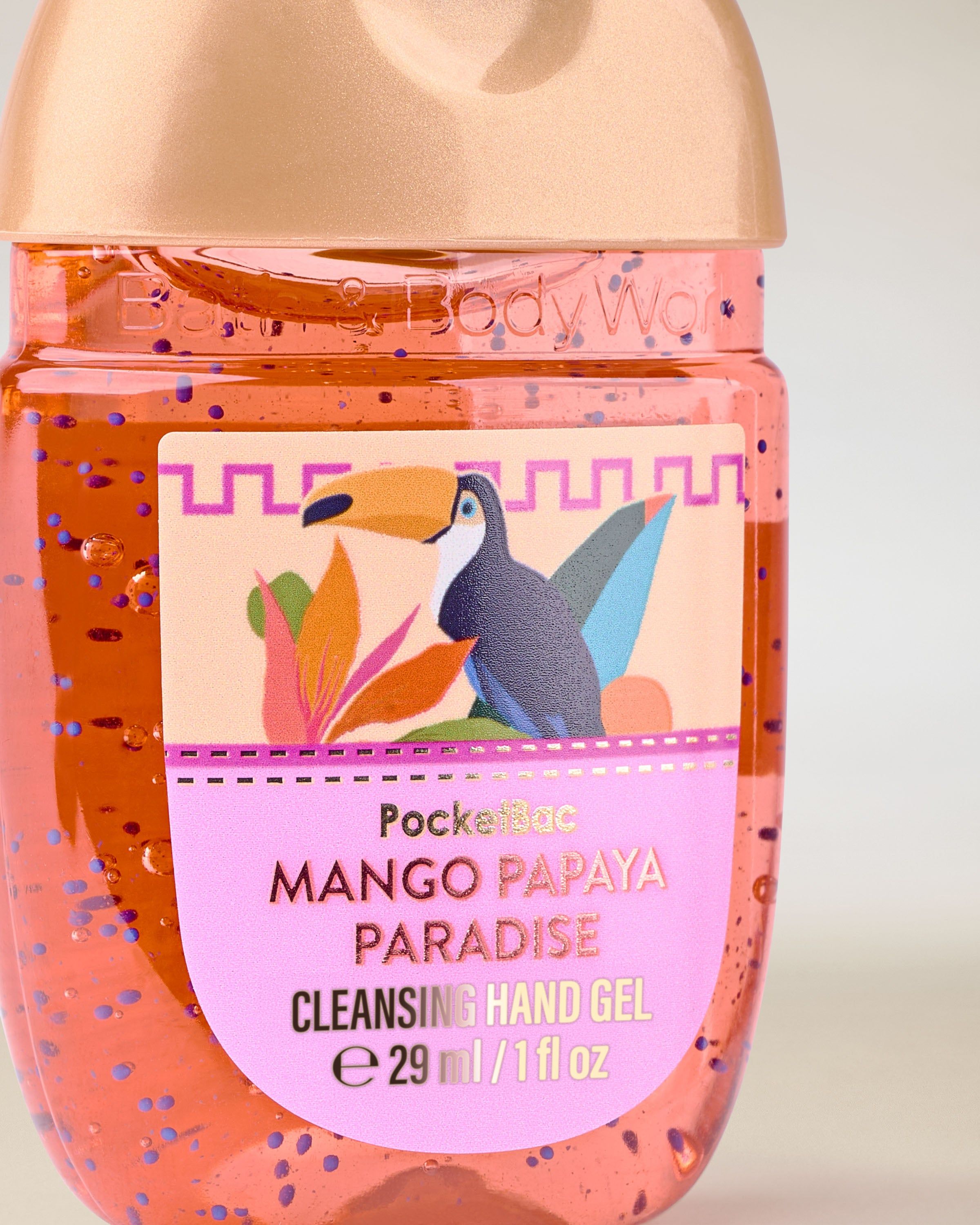 PocketBac Mango Papaya Paradise – gel na ruce v oranžovém obalu se zlatým víčkem a tropickou etiketou.