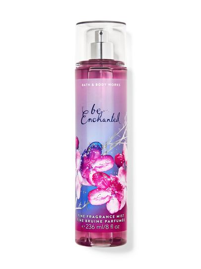 Tělová mlha "be enchanted" v růžové lahvi se třpytivými květy na etiketě. Bath & Body Works.