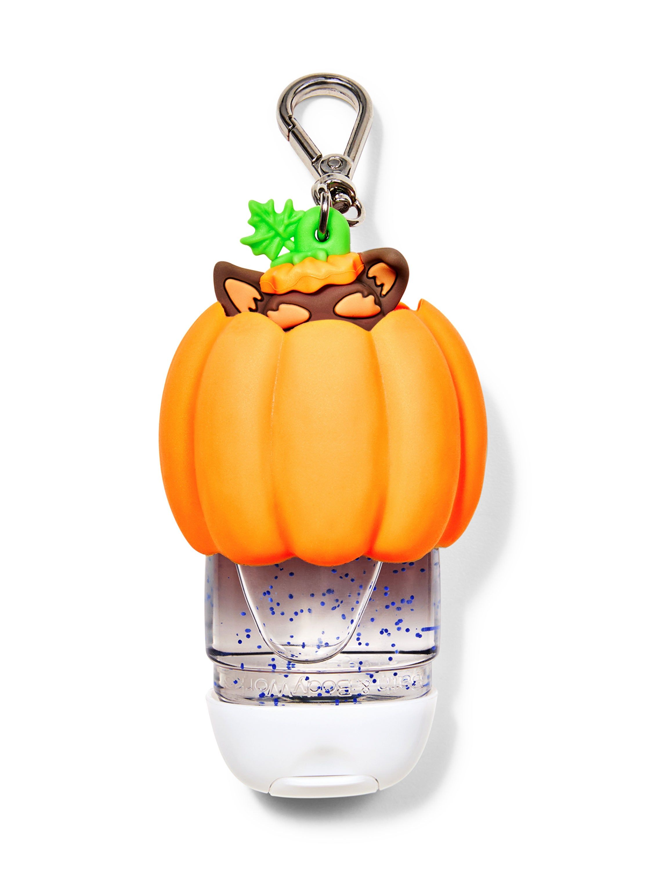 Pouzdro na gel na ruce Bath&Body Works ve tvaru psa v dýni. Oranžové pouzdro s hnědým psem a kovovou karabinou.