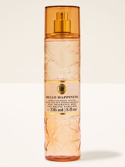 Bath & Body Works Hello Happiness – broskvová voňavá mlha v reliéfní lahvi se zlatým rozprašovačem.