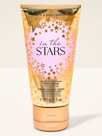 Mały krem do ciała "In the Stars" z różowym motywem i złotymi gwiazdami w błyszczącym opakowaniu. Bath & Body Works.
