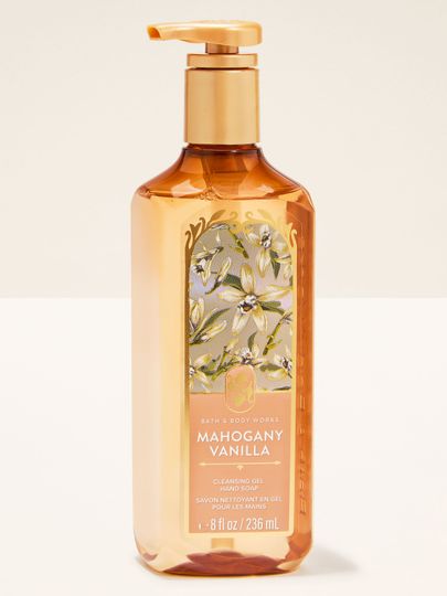 Gel na ruce Bath & Body Works „Mahogany Vanilla” — jantarová láhev s květinovým motivem.