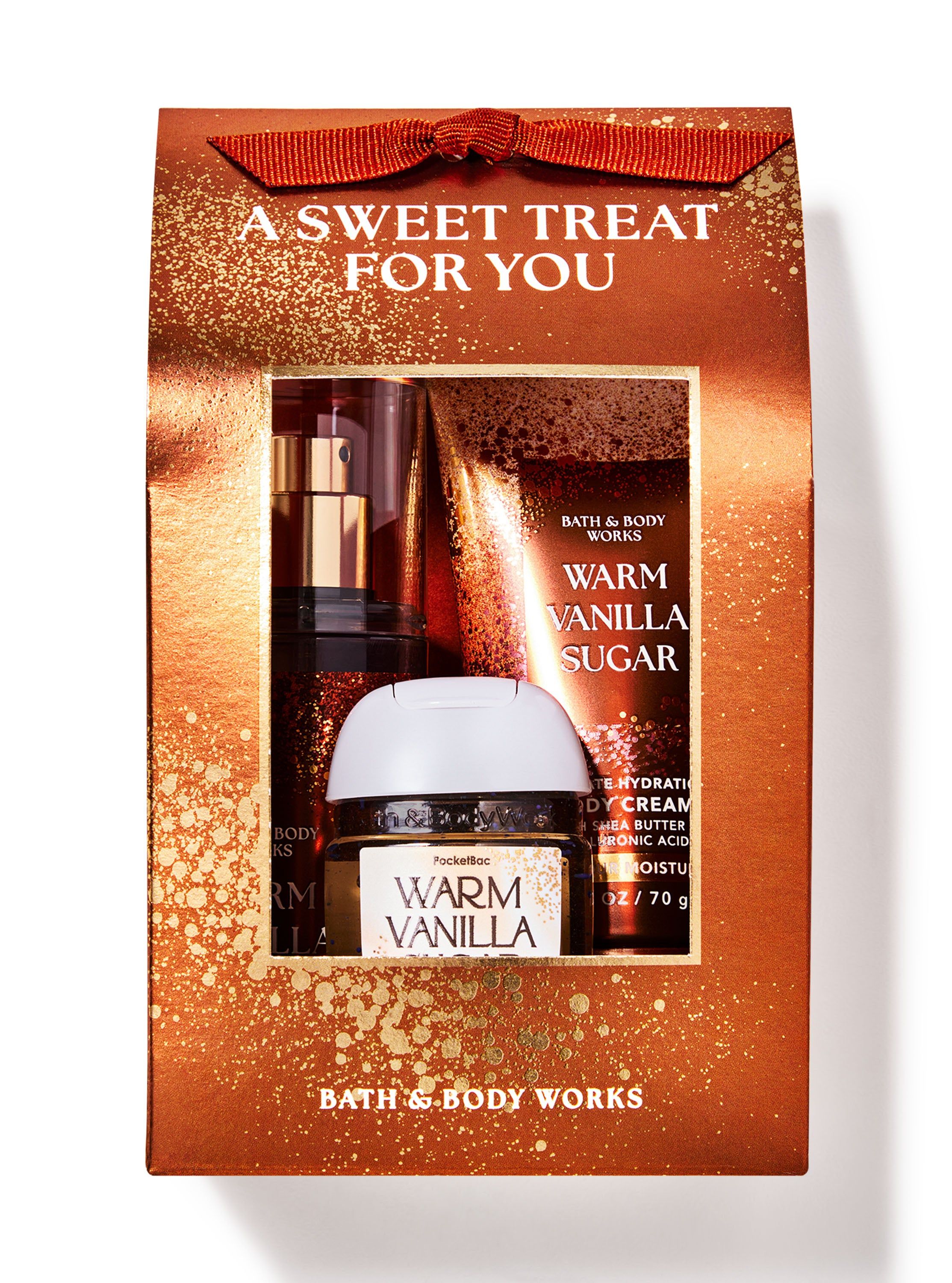 Dárková sada Warm Vanilla Sugar se sprejem, tělovým krémem a gelem na ruce v dekorativní krabičce — připravená k obdarování.
