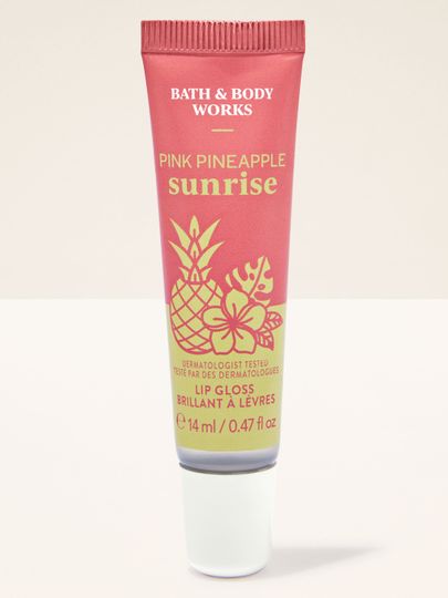 Pink Pineapple Sunrise – lesk na rty v růžové tubě s tropickým motivem ananasu a ibišku.