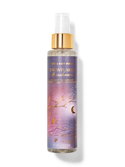 Rozświetlająca mgiełka zapachowa Snowflakes & Cashmere w fioletowej butelce z motywem zimowego drzewa. Bath&Body Works.